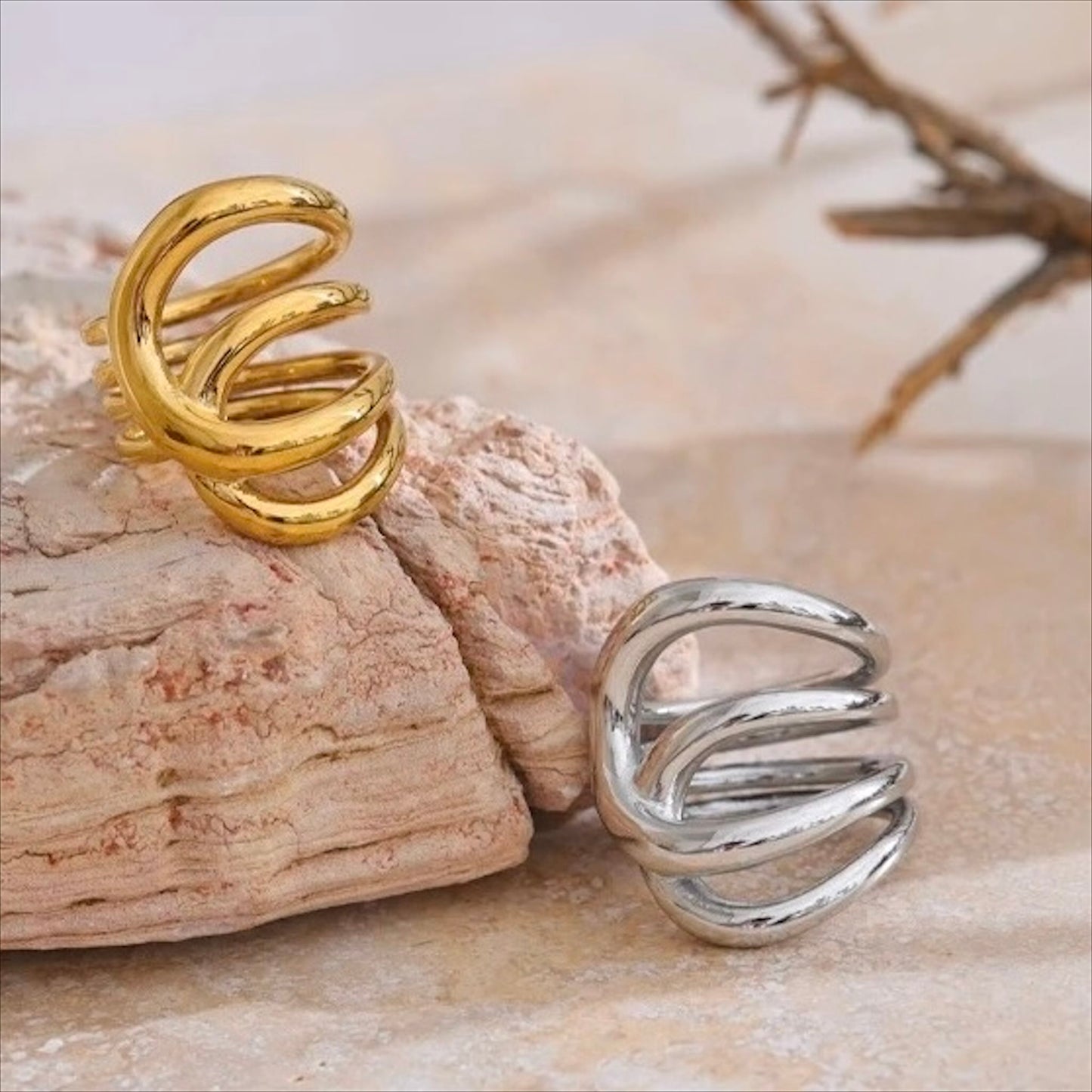 Bagues entrelacées en acier inoxydable, finitions dorée et argentée, bijou design et moderne pour femme.